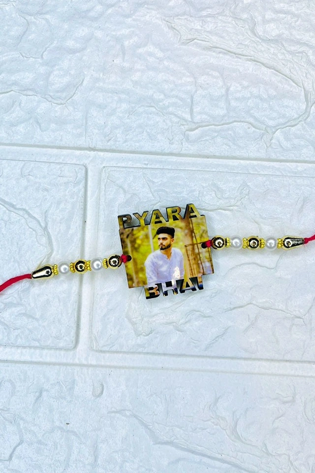 Personalized Photo Rakhi for Brother Personalized acrylic photo rakhi with "Pyara Bhai" text, custom printed brother photo, pearl and gold bead design with premium red thread for Raksha Bandhan.
